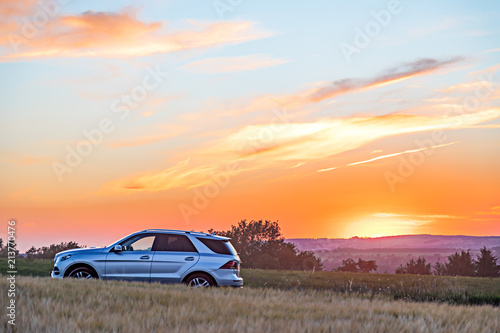 Moody sunset with cornfield and car