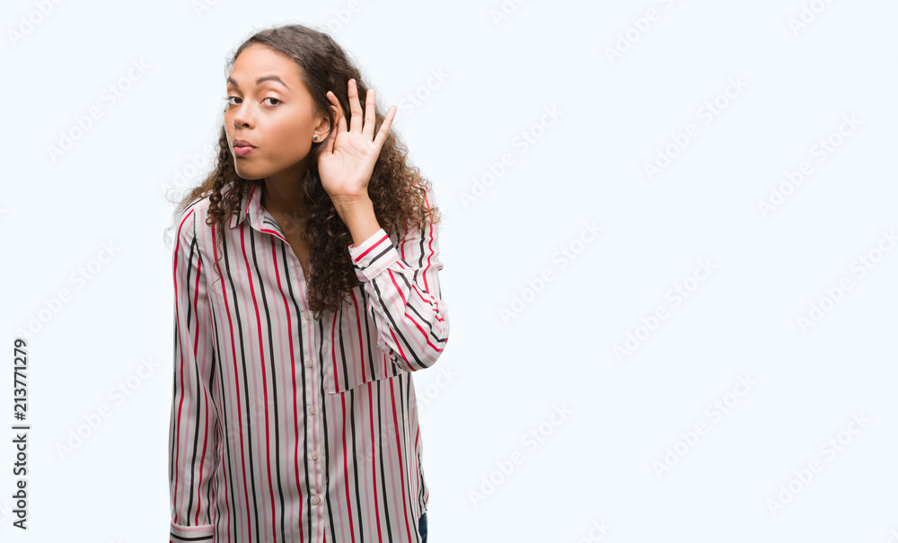 Beautiful young hispanic woman smiling with hand over ear listening an hearing to rumor or gossip. Deafness concept. Beautiful young hispanic woman smiling with hand over ear listening an hearing to rumor or gossip. Deafness concept.