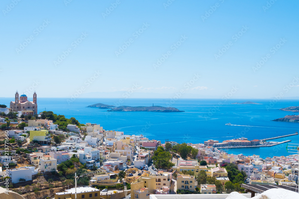 Panoramic view of Ermoupoli city of Syros Island in Cyclades, Greece. Top view of the colorful houses, the port and the Orthodox Anastaseos church