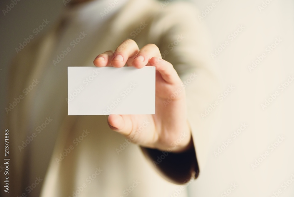 Businessman holding empty business card with copy space. Mock up. Business, study, network concept. Sunlight bokeh effect. Banner Businessman holding empty business card with copy space. Mock up. Business, study, network concept. Sunlight bokeh effect. Banner