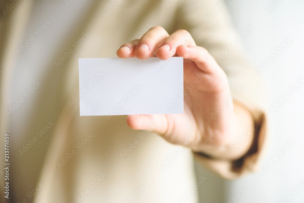 Businessman holding empty business card with copy space. Mock up. Business, study, network concept. Businessman holding empty business card with copy space. Mock up. Business, study, network concept.