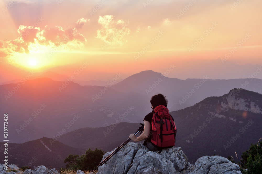 Fototapeta premium .female hiker resting and watching the sunset