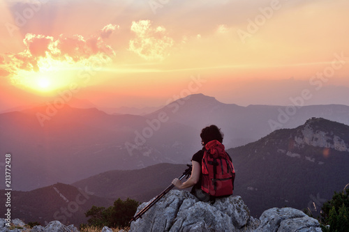.female hiker resting and watching the sunset