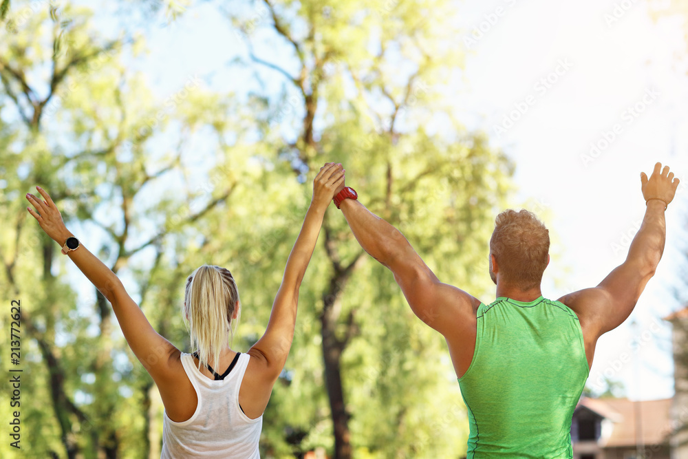 Obraz premium Young couple working out in park