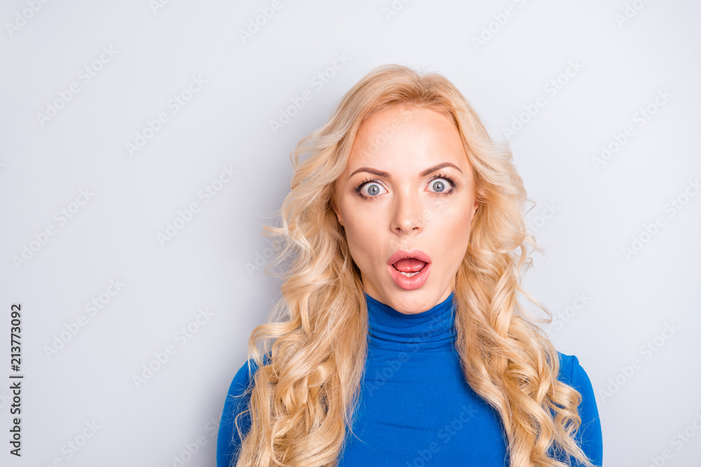 Portrait of sexy, scared, impressed, shocked, stylish, pretty, cute, charming, nice, blonde woman in blue turtleneck with wide open eyes and mouth looking at camera Portrait of sexy, scared, impressed, shocked, stylish, pretty, cute, charming, nice, blonde woman in blue turtleneck with wide open eyes and mouth looking at camera
