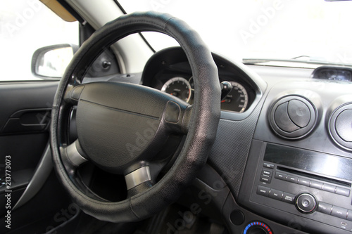 Simple steering wheel on the car dashboard