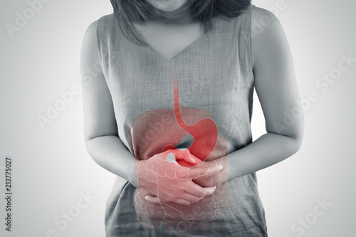 Ulcerative Colitis, The photo of large intestine is on the woman's body against gray background, Female anatomy, Concept with healthcare and medicine