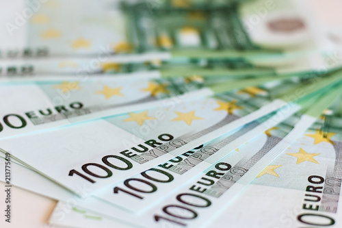 European currency, one hundred Euro banknotes, blurred photo with selective focus