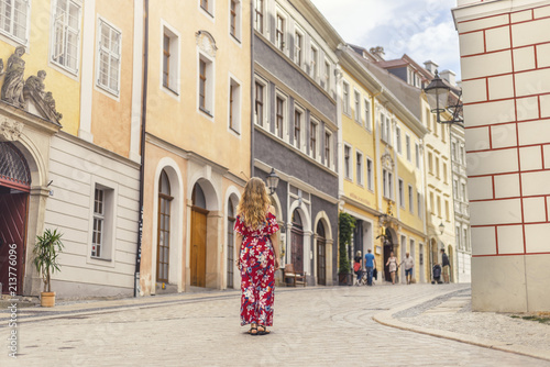 Young woman in red dress taking tour in old german town © seligaa
