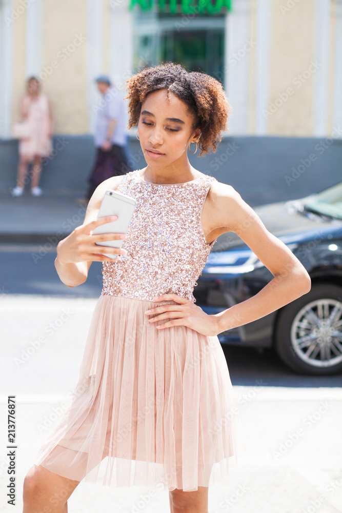 Young beautiful girl is photographing herself on a mobile phone Young beautiful girl is photographing herself on a mobile phone