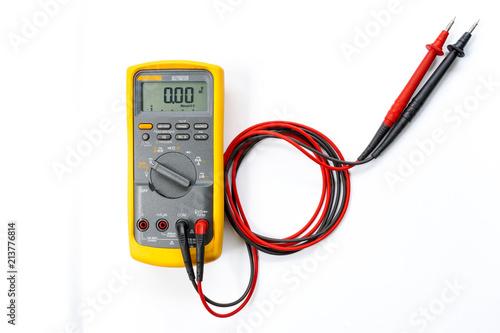 Yellow Digital multimeter with probes on white background , A multimeter  is an electronic measuring instrument.
