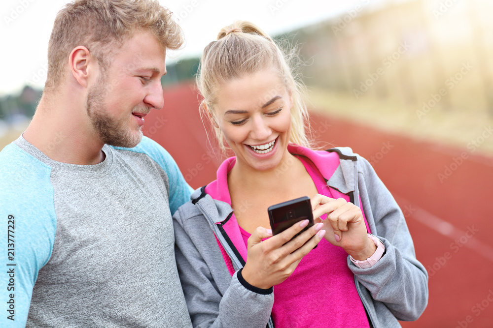 Man and woman racing on outdoor track Man and woman racing on outdoor track