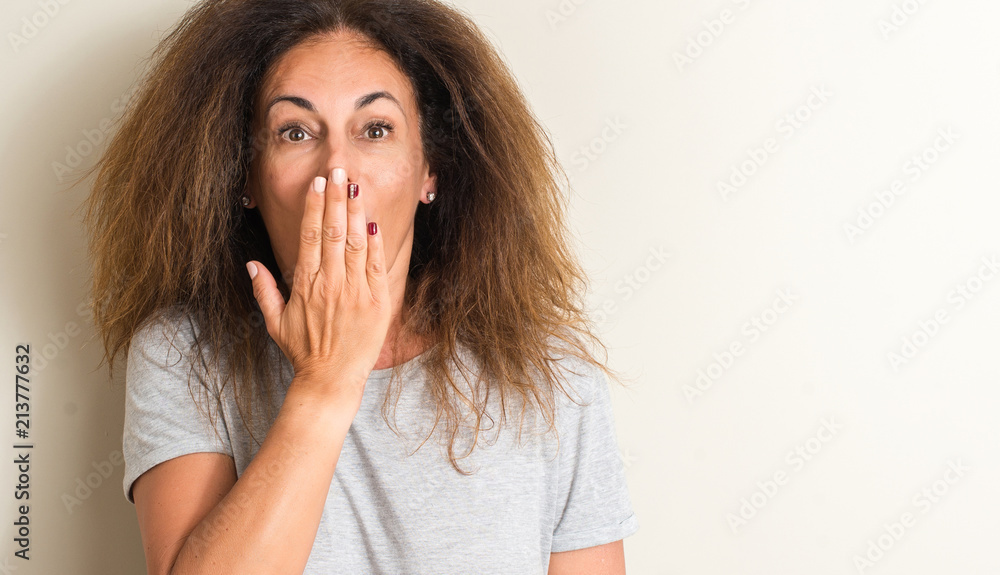 Curled hair brazilian woman cover mouth with hand shocked with shame for mistake, expression of fear, scared in silence, secret concept Curled hair brazilian woman cover mouth with hand shocked with shame for mistake, expression of fear, scared in silence, secret concept