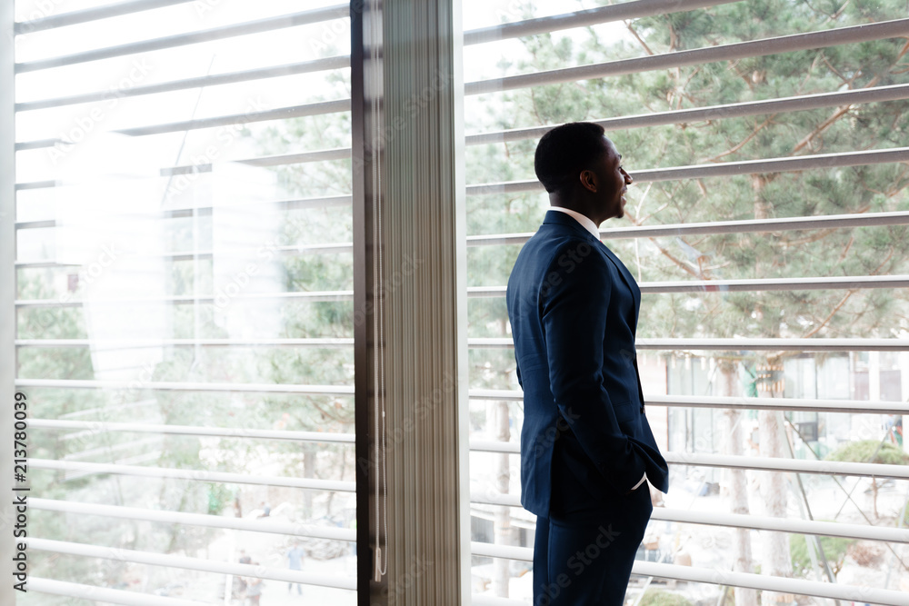Handsome cheerful african american executive business man at the workspace office Handsome cheerful african american executive business man at the workspace office