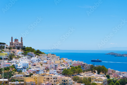 Panoramic view of Ermoupoli city of Syros Island in Cyclades, Greece. Top view of the colorful houses, the port and the Orthodox Anastaseos church