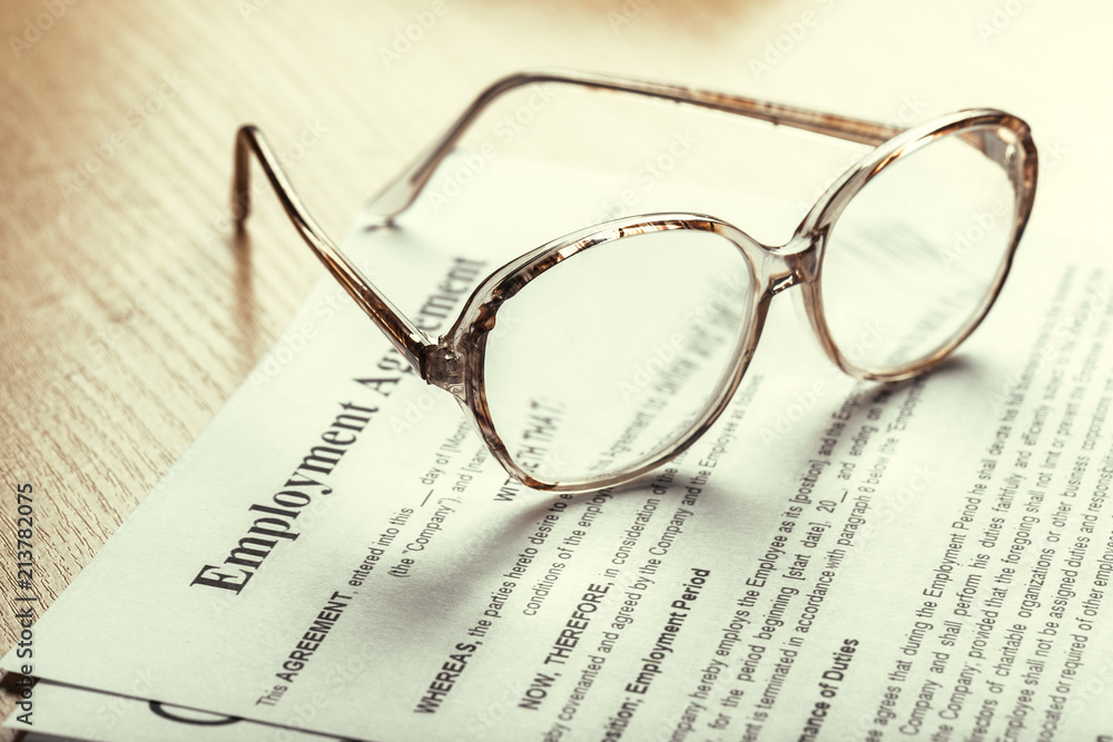 Close up shot of Eyeglasses on contract document papers business concept Close up shot of Eyeglasses on contract document papers business concept