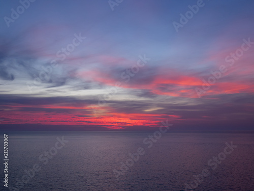Red and purple sky above sea © Doug Armand