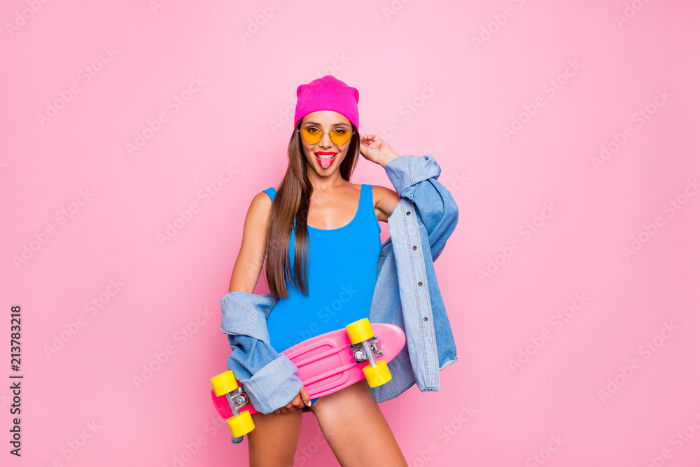 Fototapeta premium Happiness lifestyle leisure hobby skater people person concept. Photo portrait of beautiful funky attractive charming girl sticking tongue out holding longboard isolated bright background