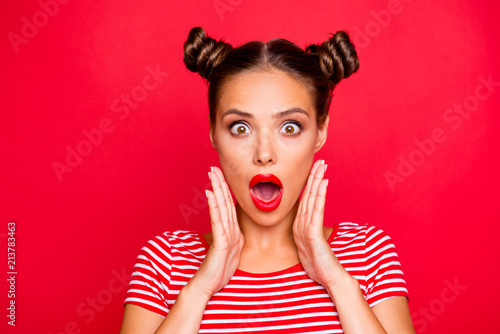 Say what? Close up portrait of  shocked brunette girl with wide open mouth and big eyes hold palms near face isolated on red vivid background photo