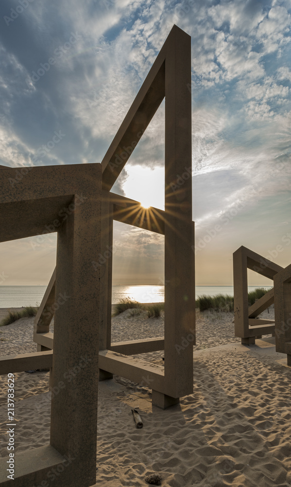 wooden structure on beach during sunset wooden structure on beach during sunset