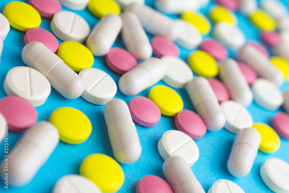 Heap of pills or tablets capsule plastic drugs bottle blue background. medicine for various diseases hospital concept. Heap of pills or tablets capsule plastic drugs bottle blue background. medicine for various diseases hospital concept.