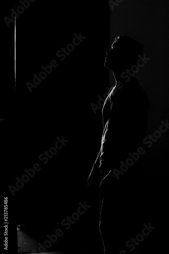 Iluminated man silhouette on black background