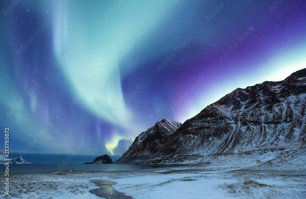 Northen light above mountains and ocean. Beautiful natural landscape in the Norway