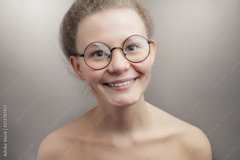 pleasant nude woman wearing round glasses.isolated grey background isolated white background