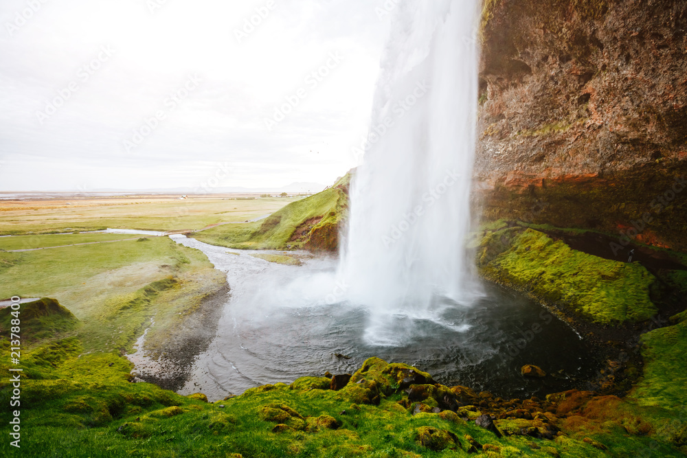 Perfect view of famous powerful Seljalandfoss waterfall in sunlight. Perfect view of famous powerful Seljalandfoss waterfall in sunlight.