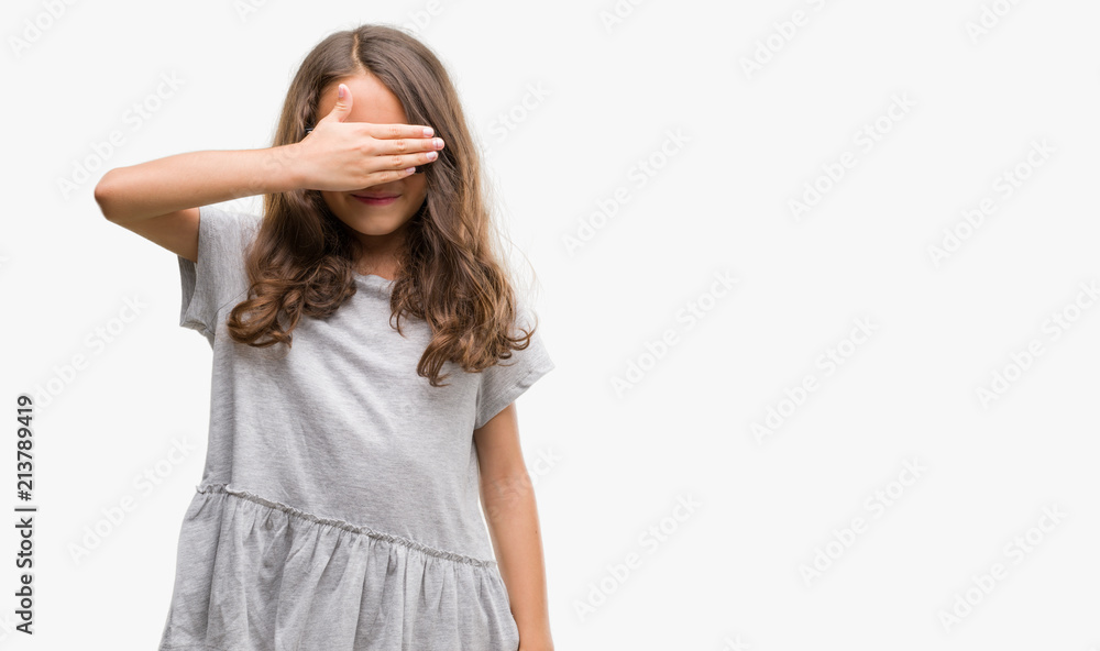 Brunette hispanic girl wearing sunglasses smiling and laughing with hand on face covering eyes for surprise. Blind concept. Brunette hispanic girl wearing sunglasses smiling and laughing with hand on face covering eyes for surprise. Blind concept.