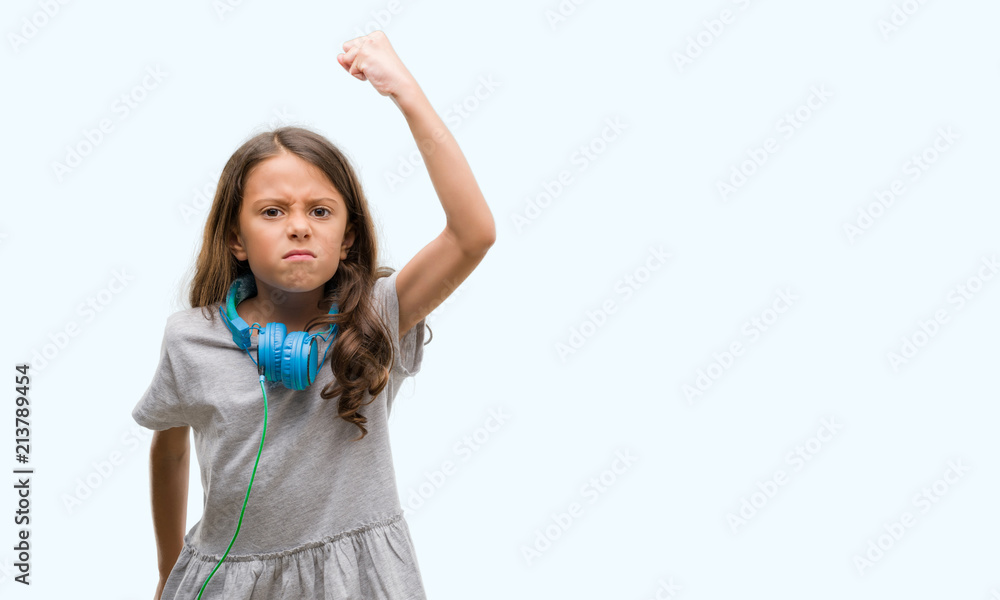 Brunette hispanic girl wearing headphones annoyed and frustrated shouting with anger, crazy and yelling with raised hand, anger concept Brunette hispanic girl wearing headphones annoyed and frustrated shouting with anger, crazy and yelling with raised hand, anger concept