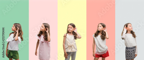 Collage of brunette hispanic girl wearing different outfits smiling with hand over ear listening an hearing to rumor or gossip. Deafness concept.