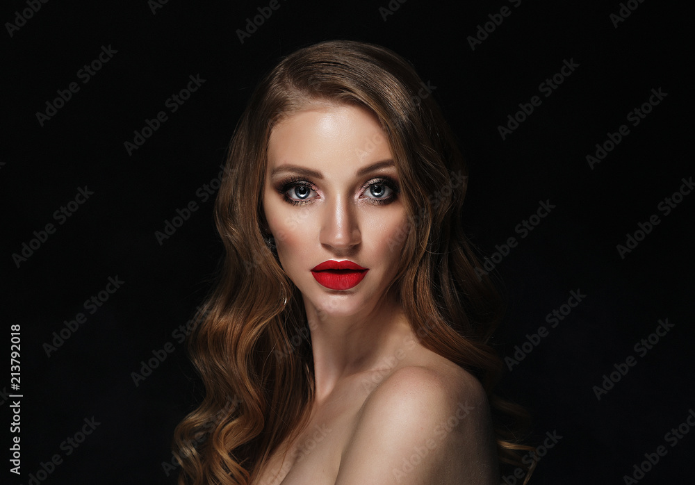 Blonde fashion girl with long and shiny curly hair. Red lips and bright make up. Blonde fashion girl with long and shiny curly hair. Red lips and bright make up.