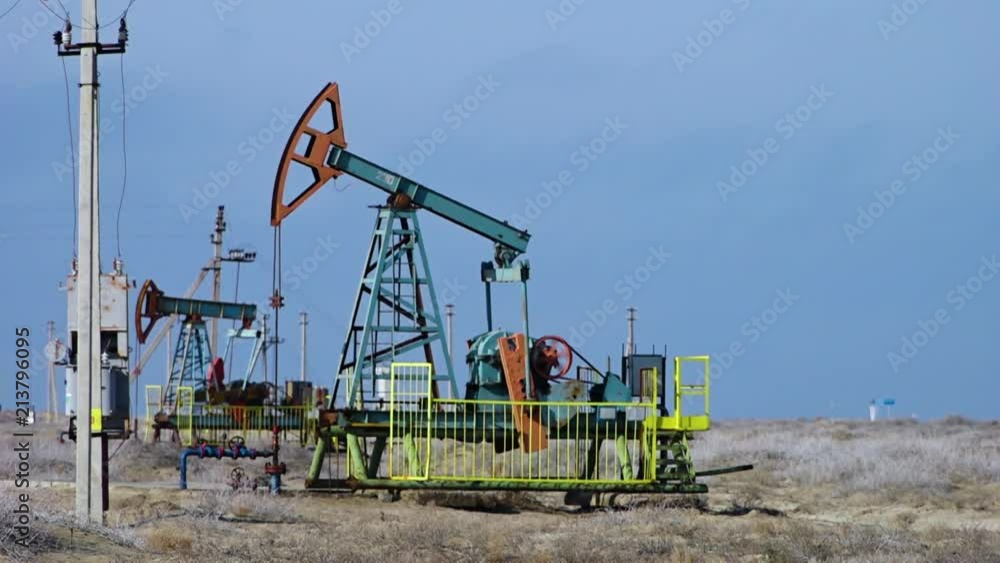 A shot of an oil pump, pumping oil from the ground. A shot of an oil pump, pumping oil from the ground.