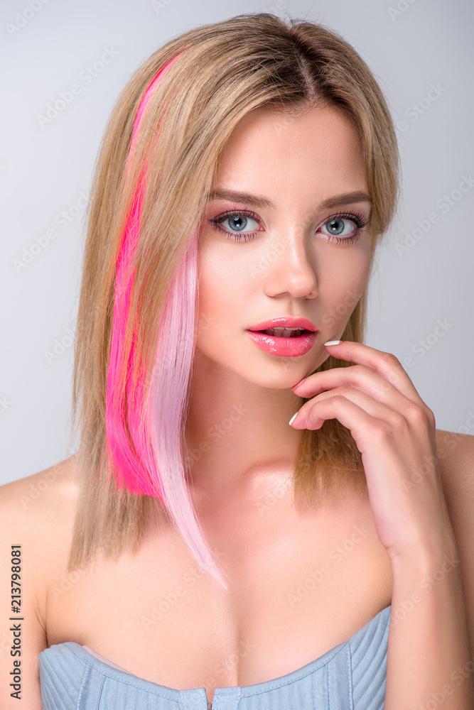 close-up portrait of beautiful young woman with colored hair strands isolated on grey close-up portrait of beautiful young woman with colored hair strands isolated on grey