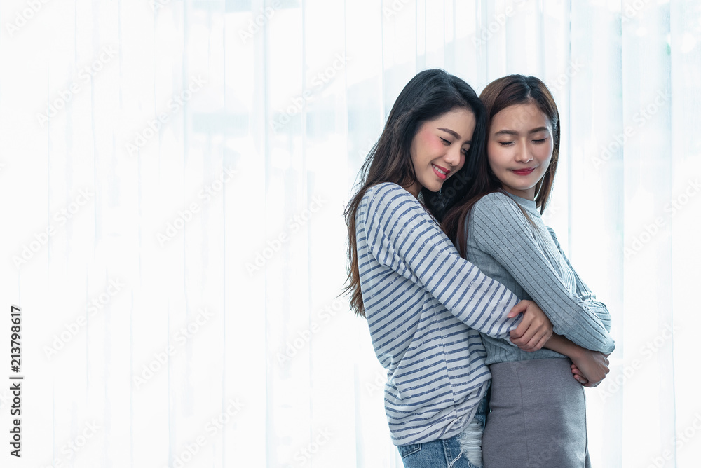 Two Asian Lesbian women hug and embracing together in bedroom. Couple people and Beauty concept. Happy lifestyles and home sweet home theme. Homosexual life theme. Love scene making of female Two Asian Lesbian women hug and embracing together in bedroom. Couple people and Beauty concept. Happy lifestyles and home sweet home theme. Homosexual life theme. Love scene making of female