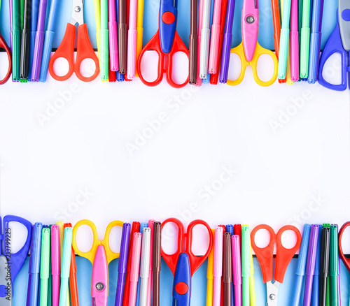 School supplies. Back to School design elements. Colorful markers and scissors on white paper background. Symmetrical design.