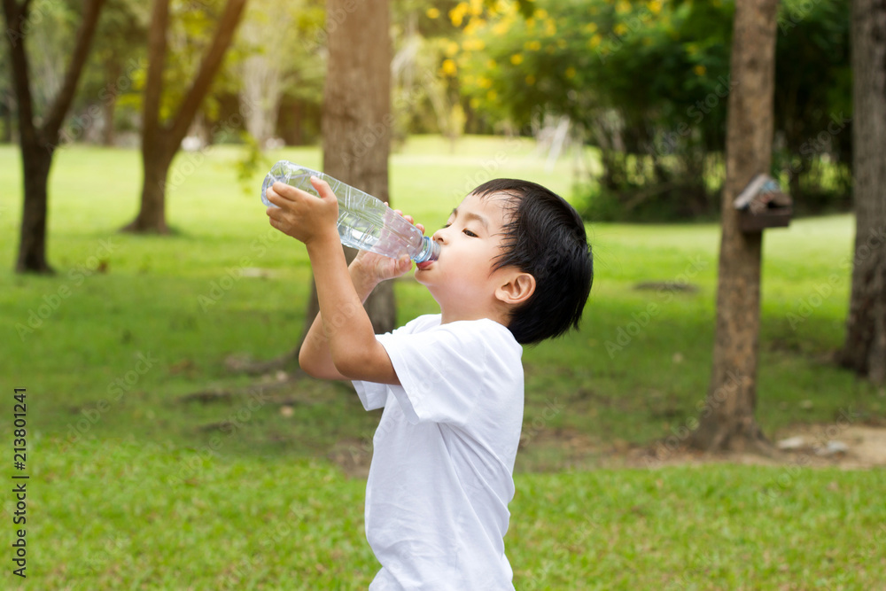 Little boy drink water at park outdoor