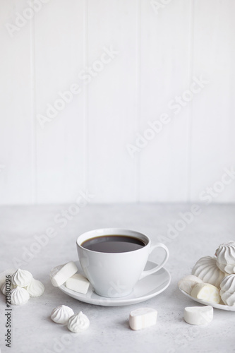 Cup of coffee on white background. Marshmallows  sweets and coffee beans.