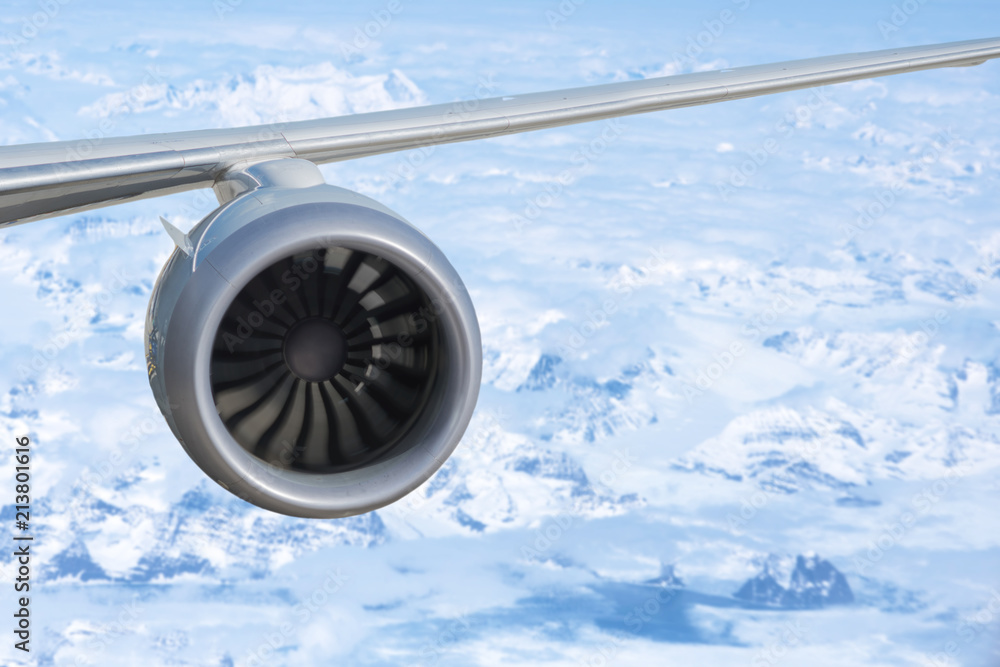 Fototapeta premium airplane engine above the Greenland with ocean and glaciers