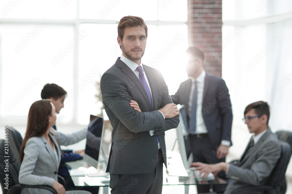 Happy businessman looking at camera with satisfaction at office Happy businessman looking at camera with satisfaction at office