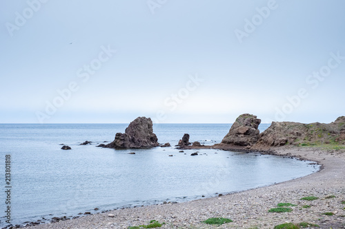 Beach with rocks in the background