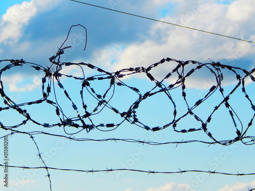 look at the sky through a barbed wire