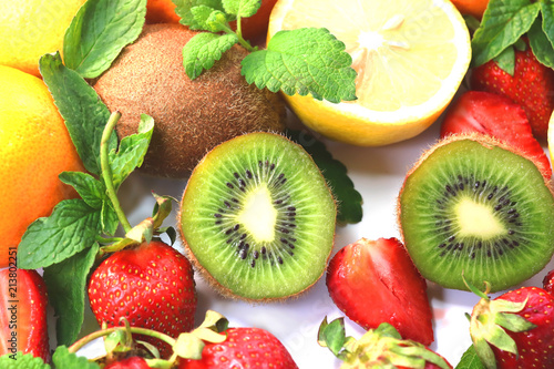 citrus fruits  and strawberries on a white background