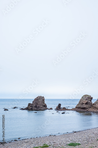 Beach with rocks in the background