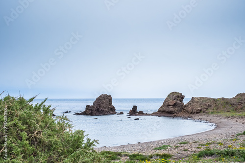 Beach with rocks in the background