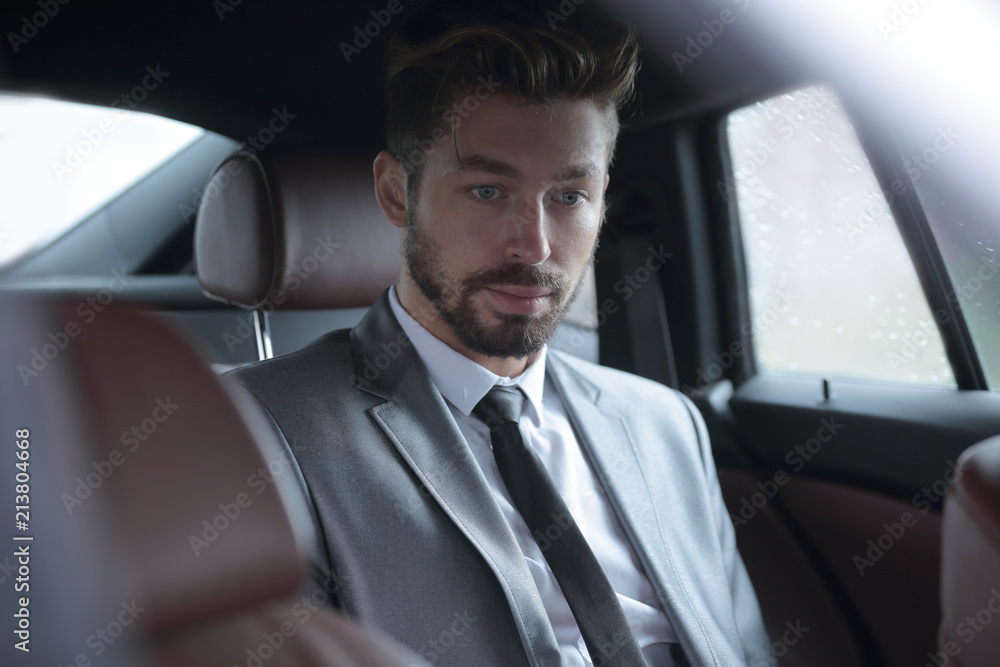 Handsome business man in car.