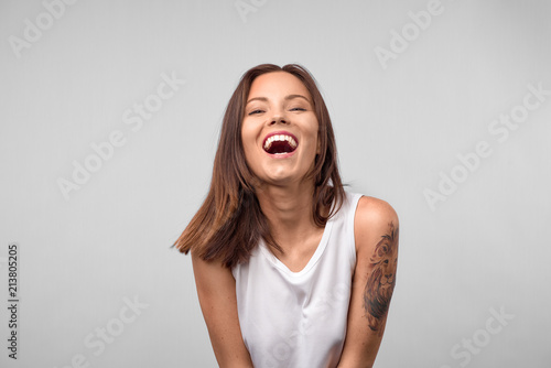 Beautiful euphoric teenage girl enjoying weekend at home, looking and smiling at camera, Cheerful happy young girl smiling laughing over white background. People and lifestyle concept