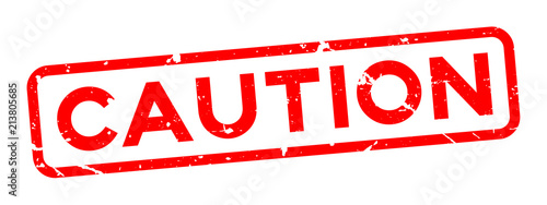 Grunge red caution word square rubber seal stamp on white background