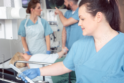 Team of nurses and doctors preparing for endoscopy examination greeting patient